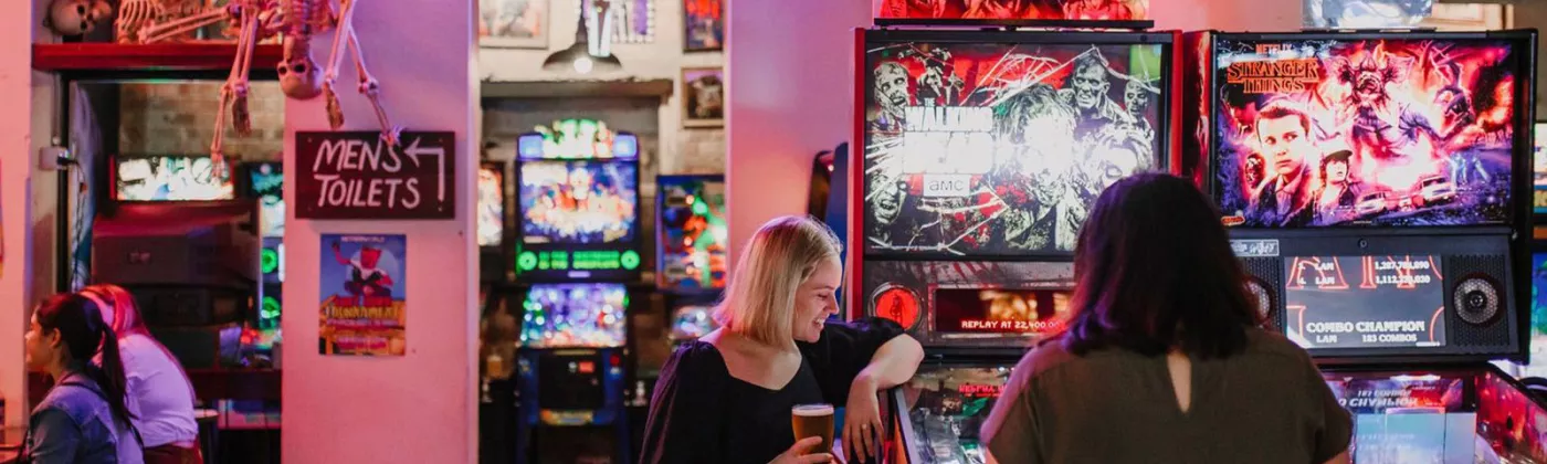 Two females playing arcade games in Netherworld