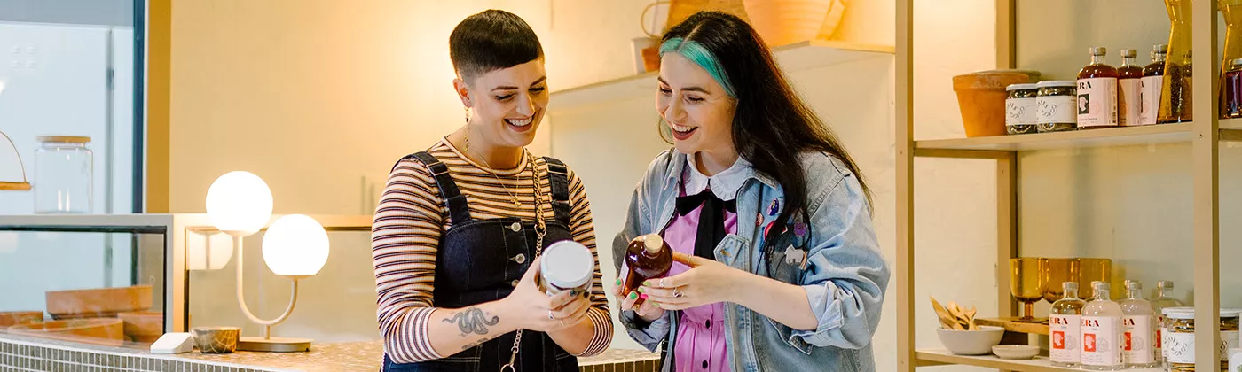 Two girls looking at products in their hands