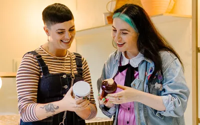 Two girls looking at products in their hands