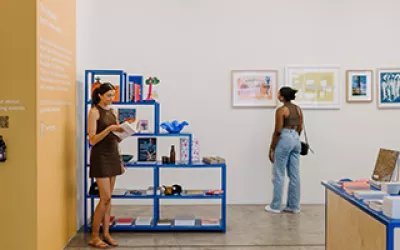 Two women looking at art in gallery