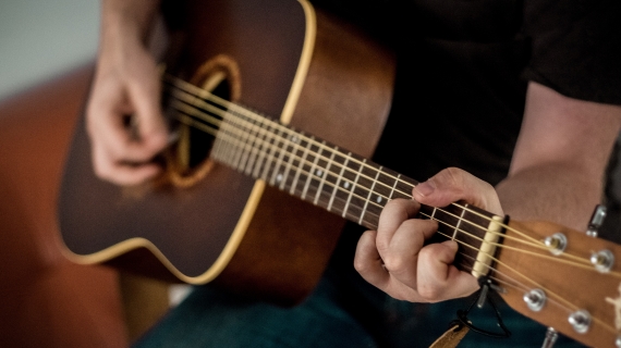  person playing acoustic guitar - Photo by 42 North from Pexels
