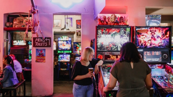 Two females playing arcade games in Netherworld