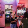 Two females playing arcade games in Netherworld