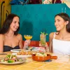 two women drinking a cocktail