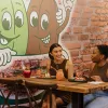 Two females enjoying breakfast and juices at Bare Beanz Cafe